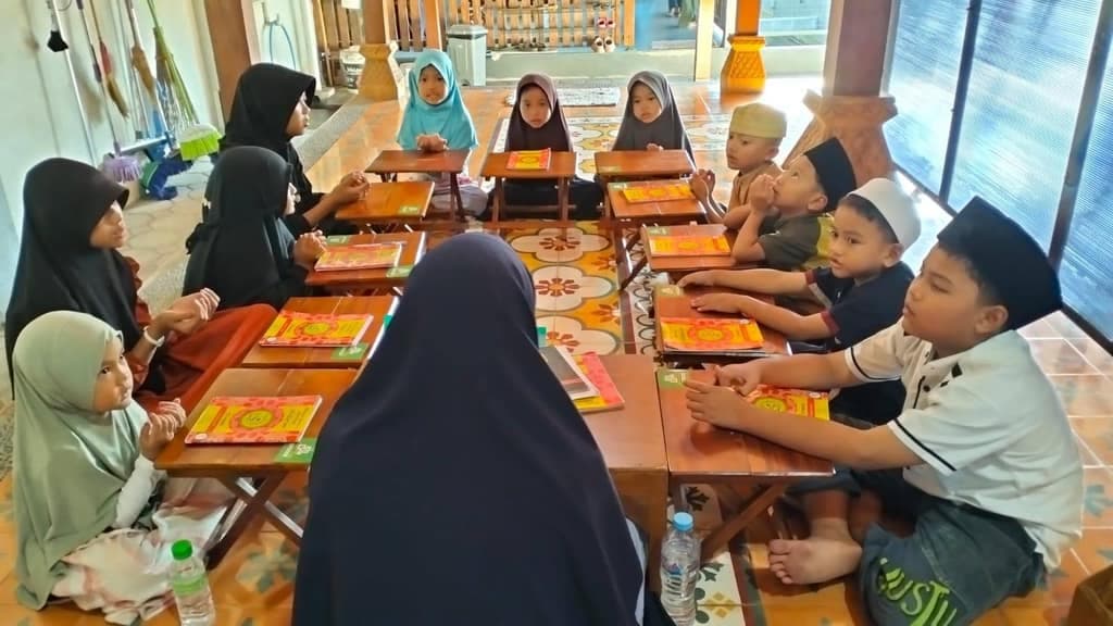 Santri belajar membaca Al-Qur'an di meja kecil
